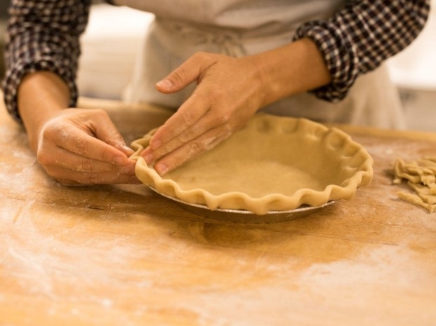 bakery shaping a pie crust
